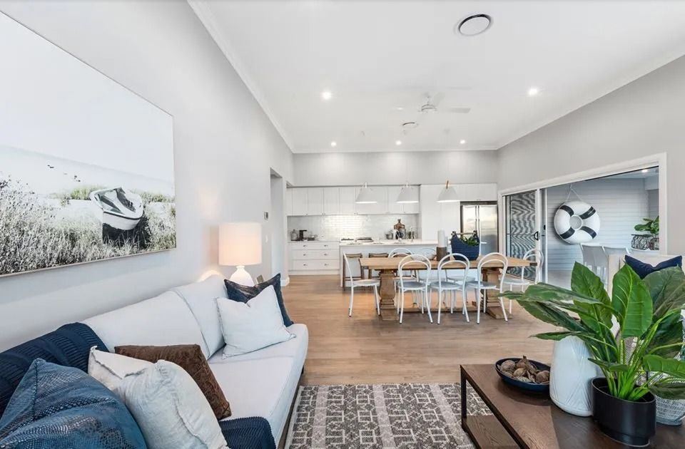 A Living Room With A Couch , Table , Chairs And A Painting On The Wall  — Norm Evans Floors Pty Ltd in Kunda Park, QLD