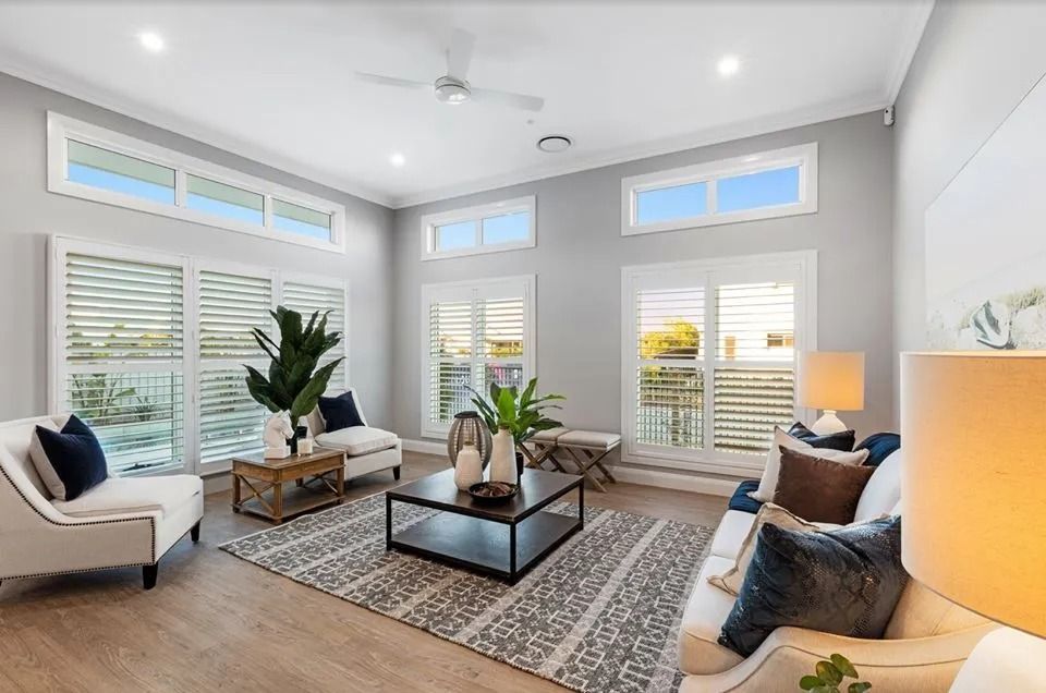 A Living Room Filled With Furniture And A Ceiling Fan  — Norm Evans Floors Pty Ltd in Kunda Park, QLD