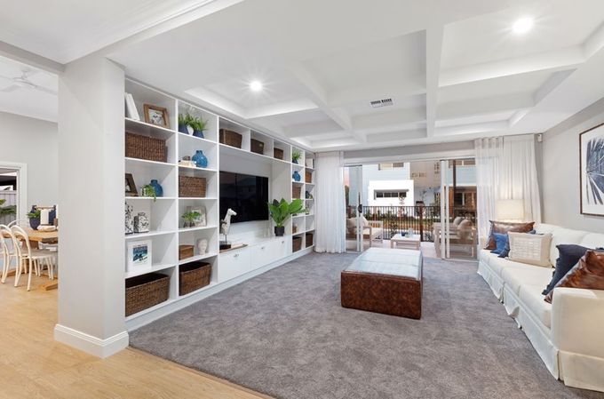 A Living Room With A Couch , Ottoman , Television And Shelves  — Norm Evans Floors Pty Ltd in Kunda Park, QLD