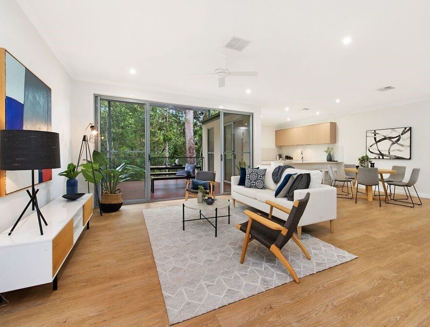 A Living Room With A Couch , Chair , Table And Rug  — Norm Evans Floors Pty Ltd in Kunda Park, QLD