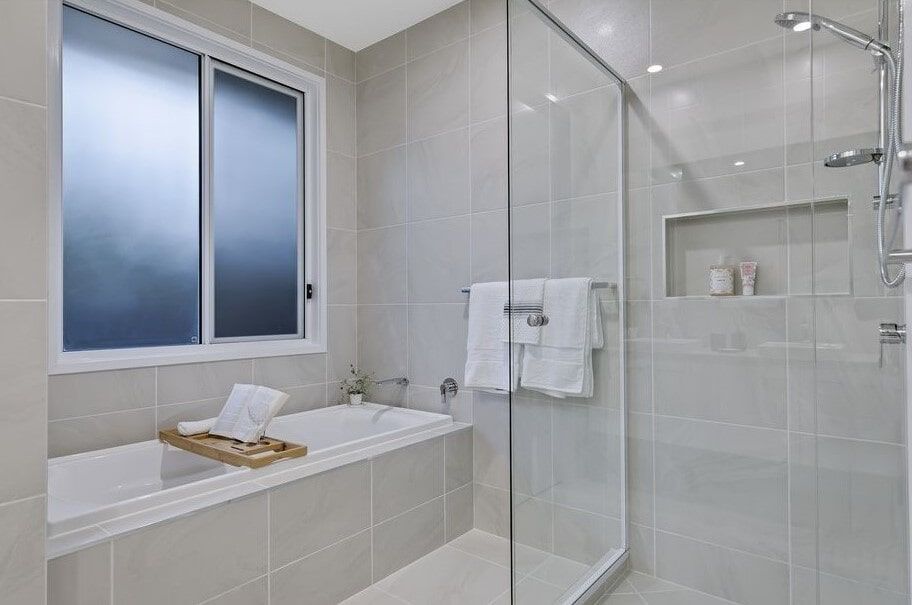 A Bathroom With A Bathtub And A Walk In Shower  — Norm Evans Floors Pty Ltd in Kunda Park, QLD
