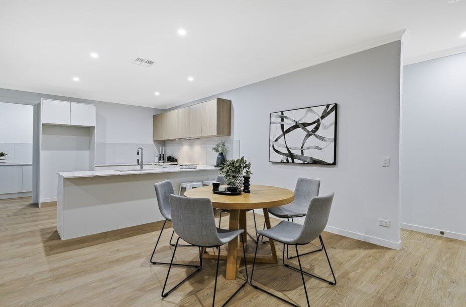 A Dining Room With A Table And Chairs In A Kitchen — Norm Evans Floors Pty Ltd in Gympie, QLD