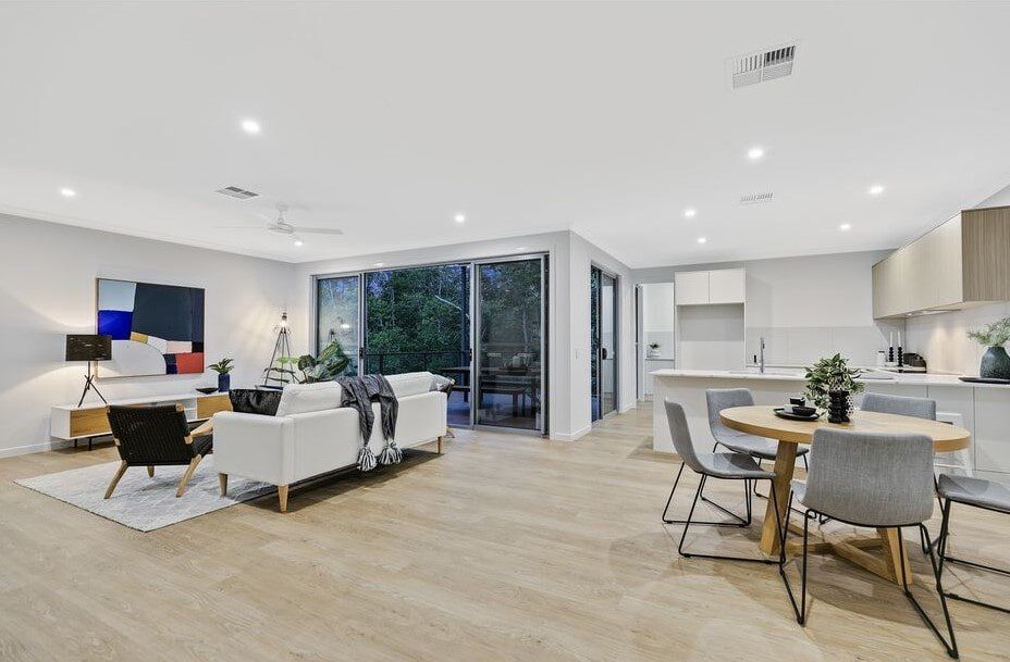 A Living Room And Dining Room In A House With A Table And Chairs — Norm Evans Floors Pty Ltd in Gympie, QLD