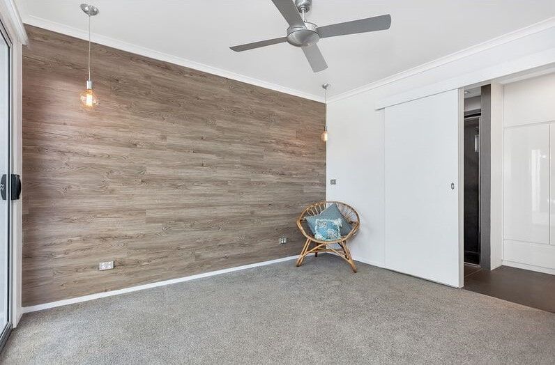 There Is A Chair In The Middle Of The Room With A Ceiling Fan  — Norm Evans Floors Pty Ltd in Kunda Park, QLD