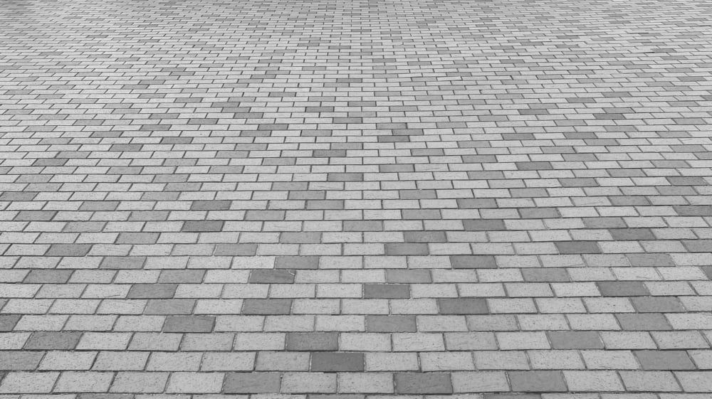 A Black And White Photo Of A Brick Pavement — Norm Evans Floors Pty Ltd in Nambour, QLD