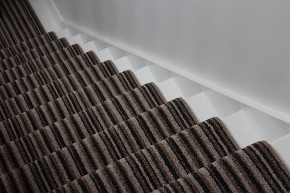 A Close Up Of A Staircase With A Brown And Black Striped Carpet — Norm Evans Floors Pty Ltd in Caloundra, QLD