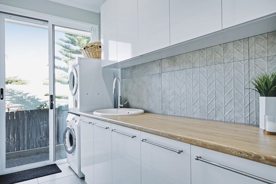 A Laundry Room With A Washer And Dryer , Sink , And Sliding Glass Doors  — Norm Evans Floors Pty Ltd in Kunda Park, QLD
