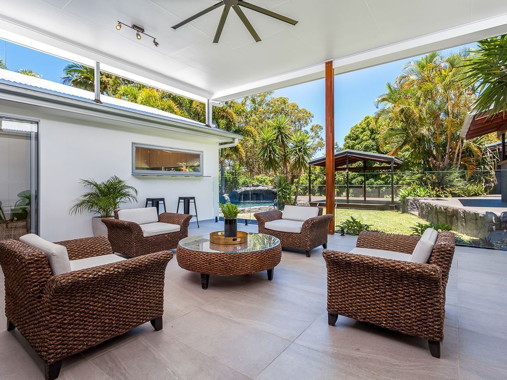 A Patio With Chairs , A Table And A Ceiling Fan  — Norm Evans Floors Pty Ltd in Kunda Park, QLD