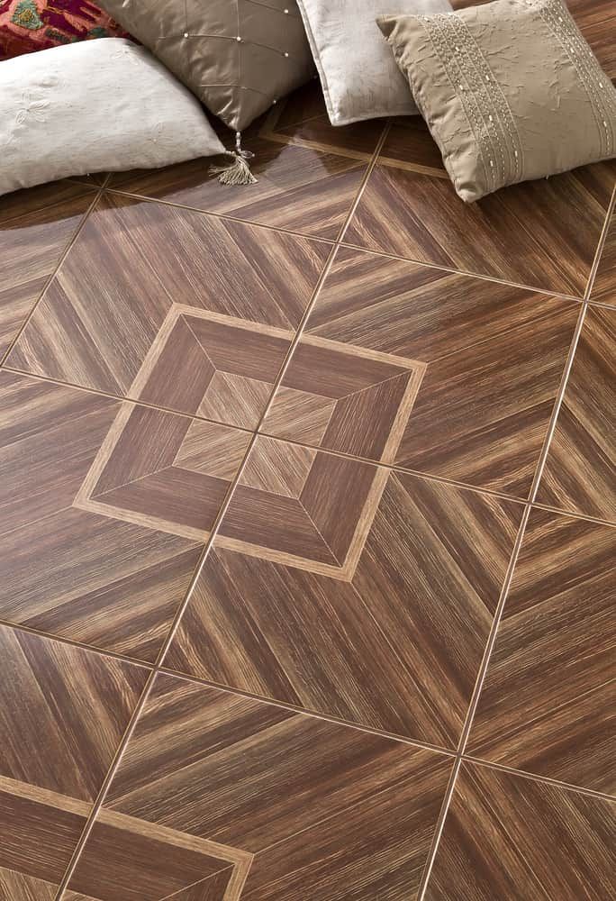 A Wooden Floor With A Geometric Pattern And Pillows On It — Norm Evans Floors Pty Ltd in Kunda Park, QLD