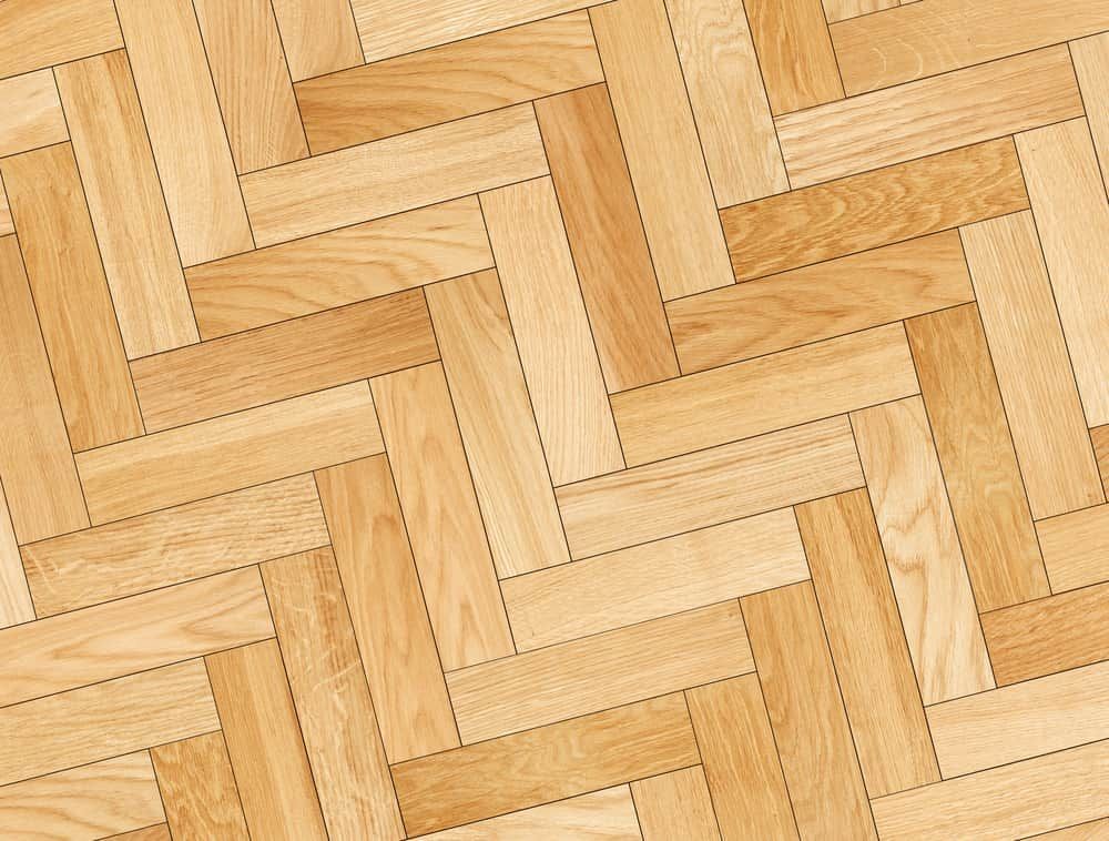 A Close Up Of A Wooden Floor With A Herringbone Pattern — Norm Evans Floors Pty Ltd in Maroochydore, QLD