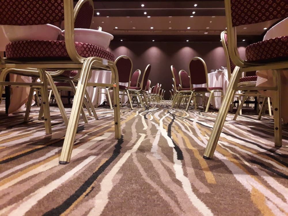 A Row Of Tables And Chairs In A Room With A Zebra Print Rug — Norm Evans Floors Pty Ltd in Maroochydore, QLD