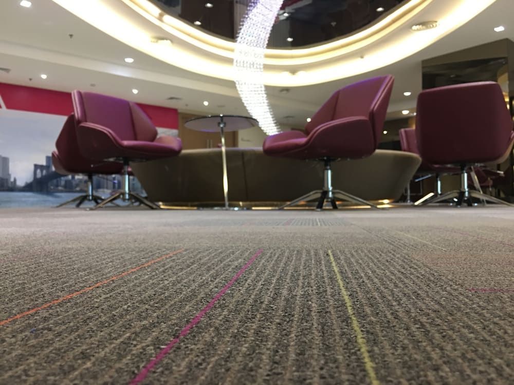 A Group Of Chairs Are Sitting In A Room With A Chandelier Hanging From The Ceiling — Norm Evans Floors Pty Ltd in Beerwah, QLD