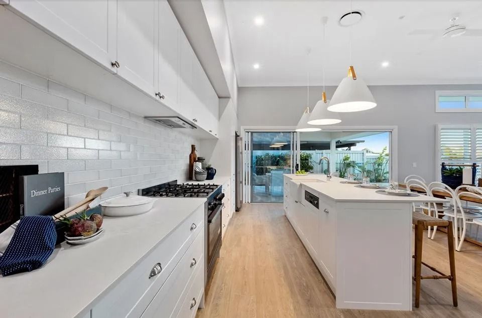A Kitchen With White Cabinets , Stainless Steel Appliances  — Norm Evans Floors Pty Ltd in Kunda Park, QLD