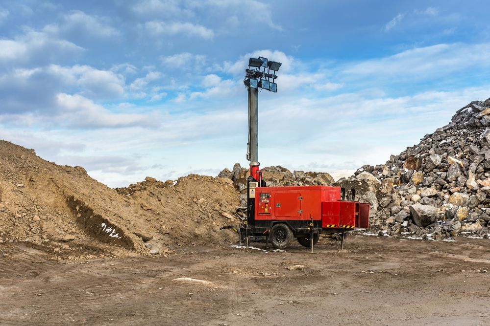 A Red Truck Is Parked In Front Of A Pile Of Dirt And Rocks — Hybrid Power Australia In Blackwater, QLD