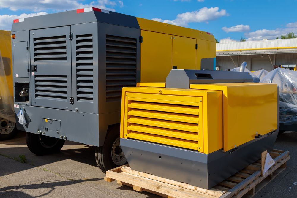 A Yellow And Gray Air Compressor Is Sitting On A Wooden Pallet — Hybrid Power Australia In Moranbah, QLD