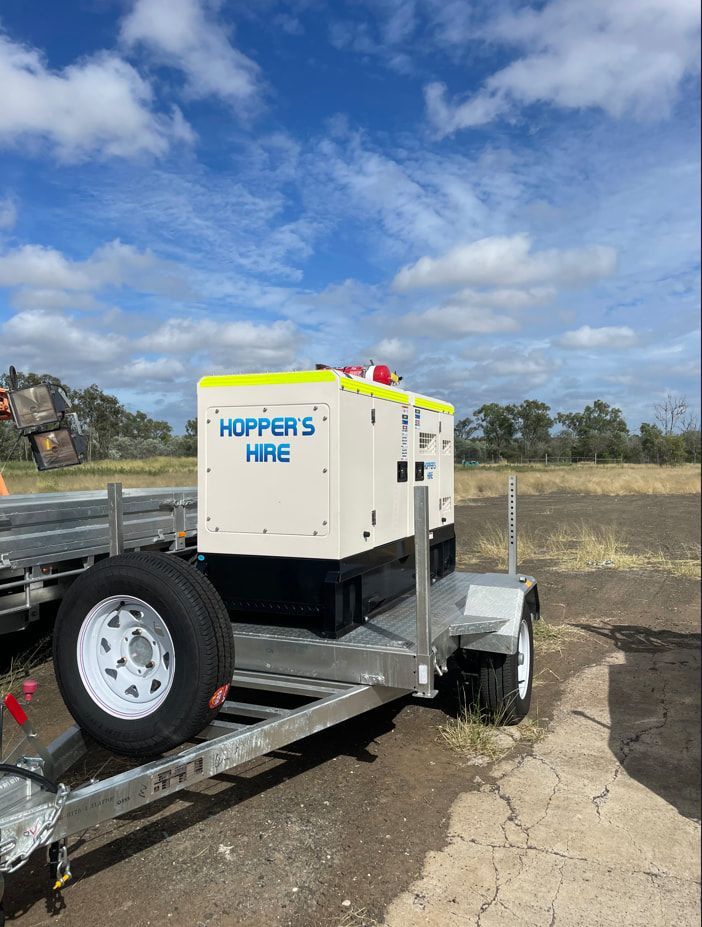 A Trailer With A Generator On It Is Parked In A Field — Hybrid Power Australia In Tieri, QLD