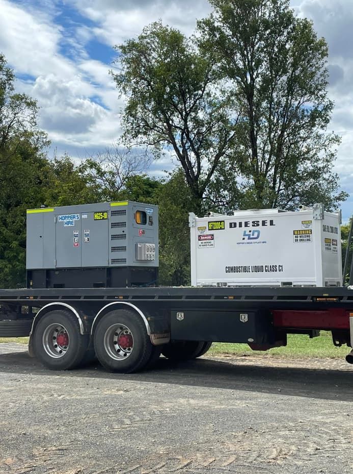 Two Generators Are On The Back Of
A Truck Parked On The Side Of The Road — Hybrid Power Australia In Tieri, QLD