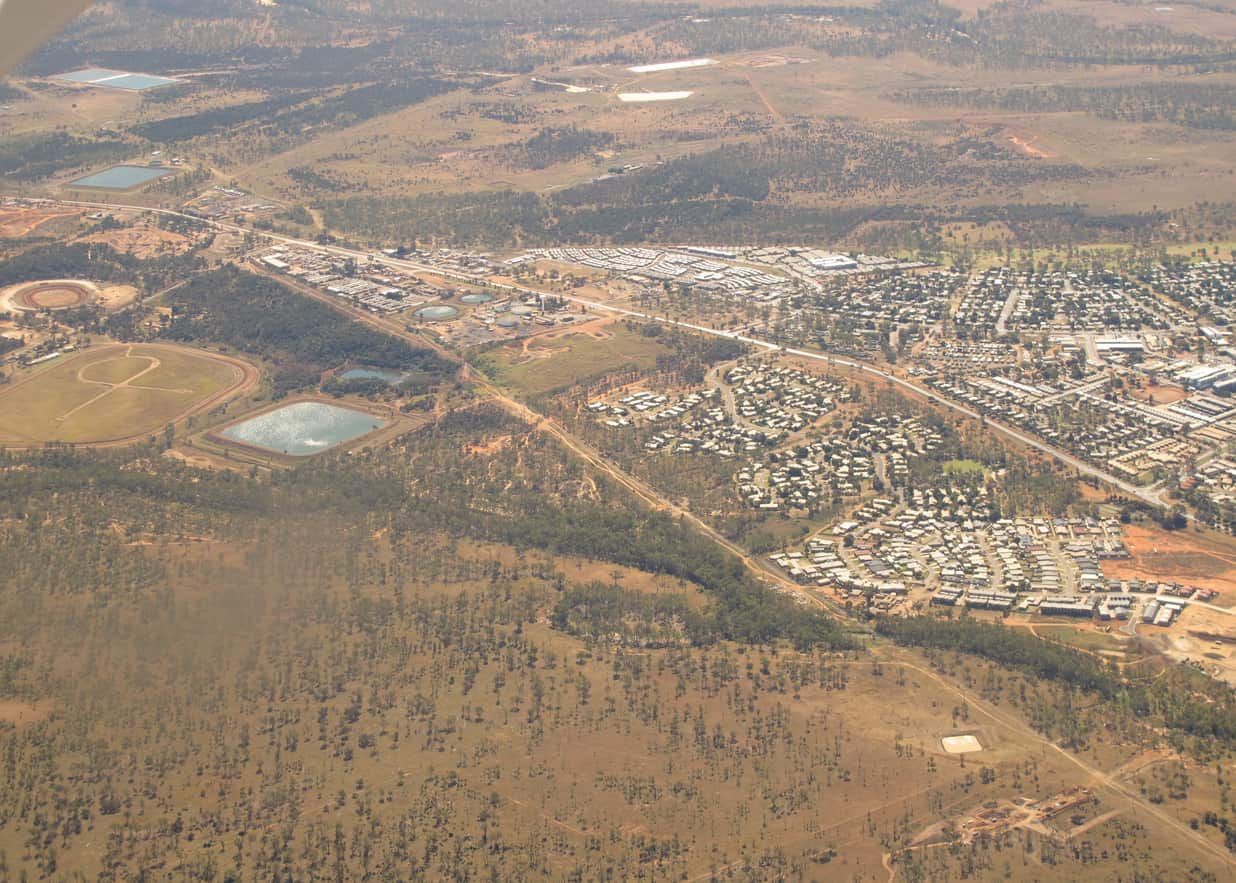 An Aerial View Of A City Surrounded By Trees And Fields — Hybrid Power Australia In Moranbah, QLD