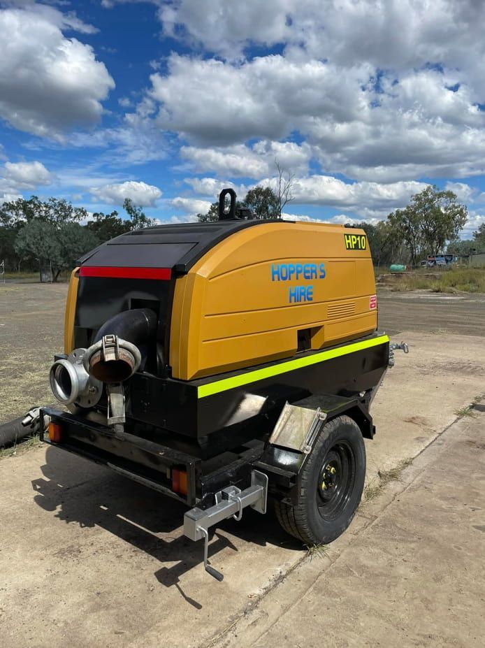 A Yellow And Black Machine On A Trailer Is Parked On The Side Of The Road — Hybrid Power Australia In Tieri, QLD