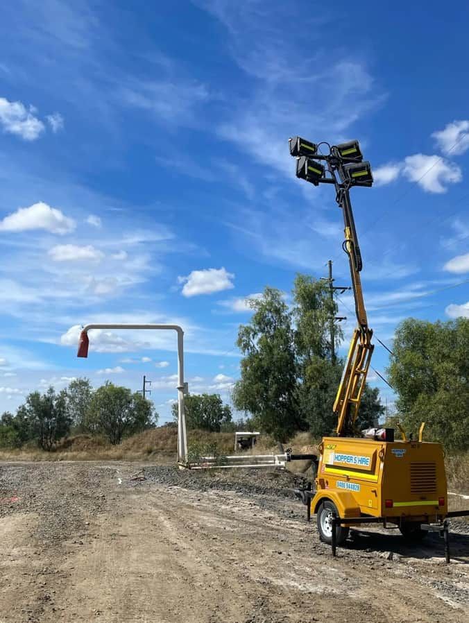A Yellow Trailer With A Light On Top Of It Is Parked In A Dirt Field — Hybrid Power Australia In Emerald, QLD