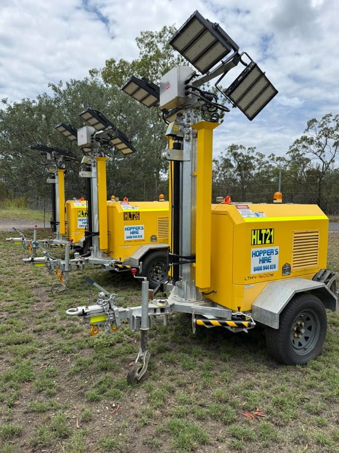 A Row Of Yellow Trailers With Words On The Side — Hybrid Power Australia In Moranbah, QLD