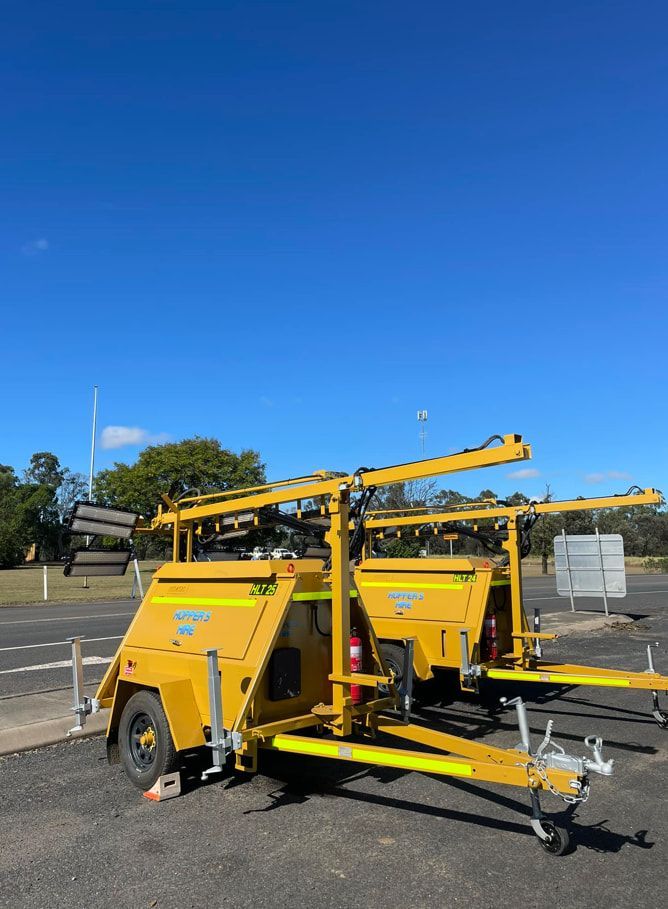 Two Yellow Trailers Are Parked Next To Each Other On The Side Of The Road — Hybrid Power Australia In Tieri, QLD