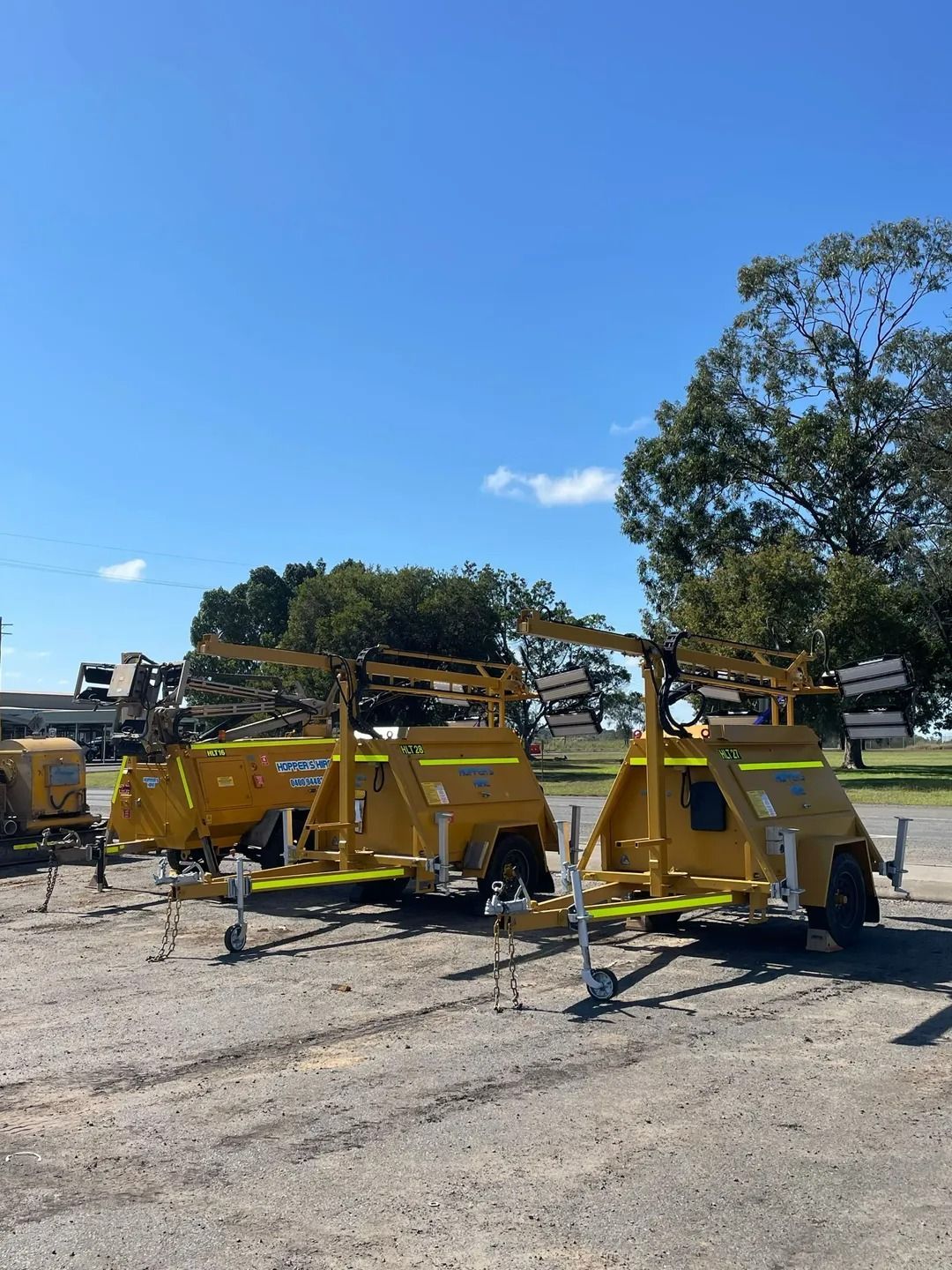 Two Yellow Mobile Light Towers Parked Outdoors — Hybrid Power Australia in Dysart, QLD