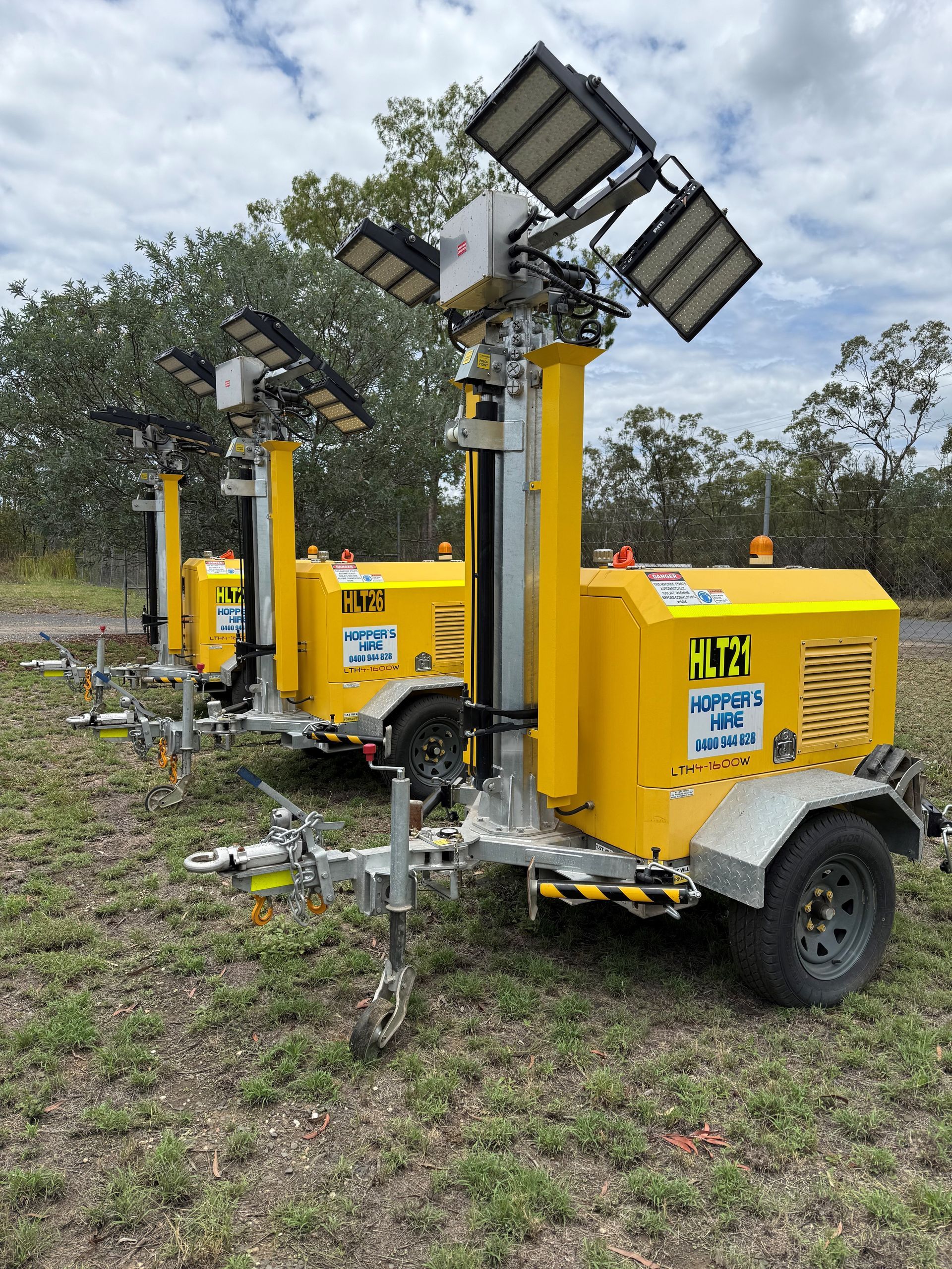 A Row Of Solar Panels On A Roof With Trees In The Background — Hybrid Power Australia In Tieri, QLD
