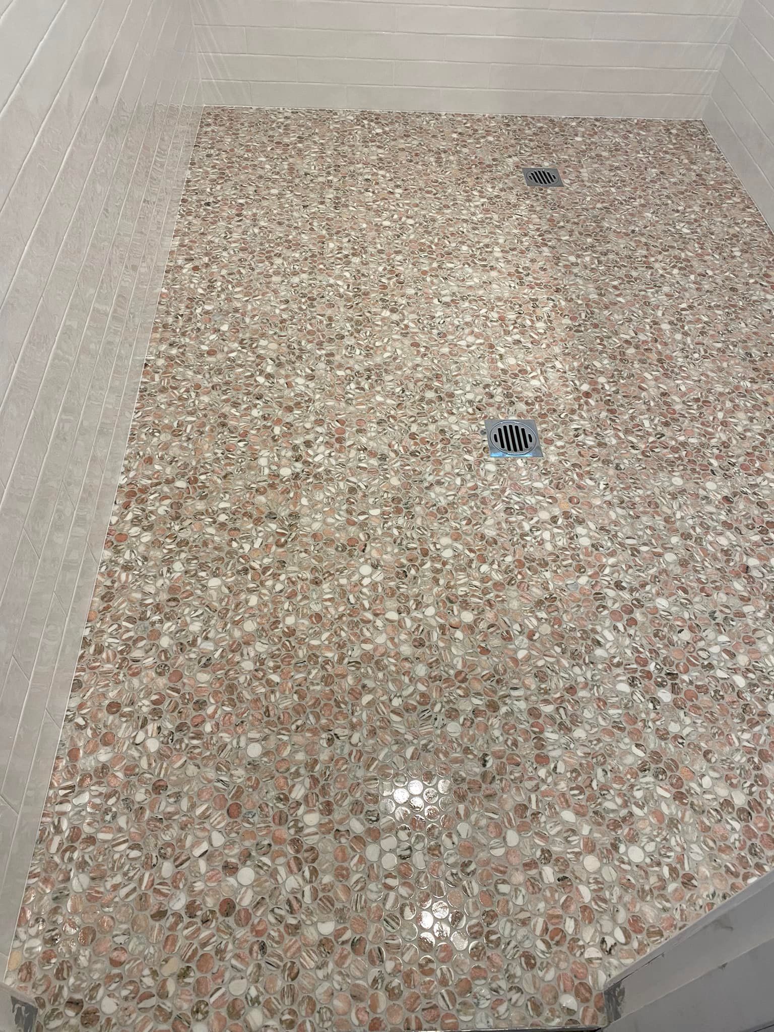 A Shower Floor With Small, Speckled Pink and Mosaic Tiles — Corrimal Discount Tiles and Bathroomwear in East Corrimal, NSW