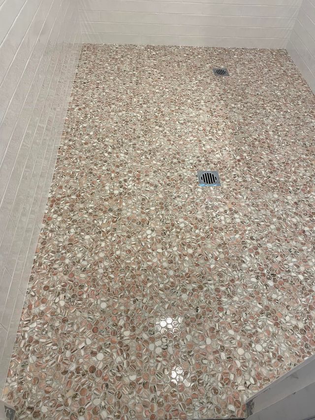 A Shower Floor With Small, Speckled Pink and Mosaic Tiles — Corrimal Discount Tiles and Bathroomwear in East Corrimal, NSW