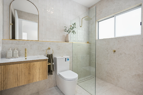 A Bathroom with A Toilet, Sink, Mirror and Walk in Shower — Corrimal Discount Tiles and Bathroomwear in East Corrimal, NSW