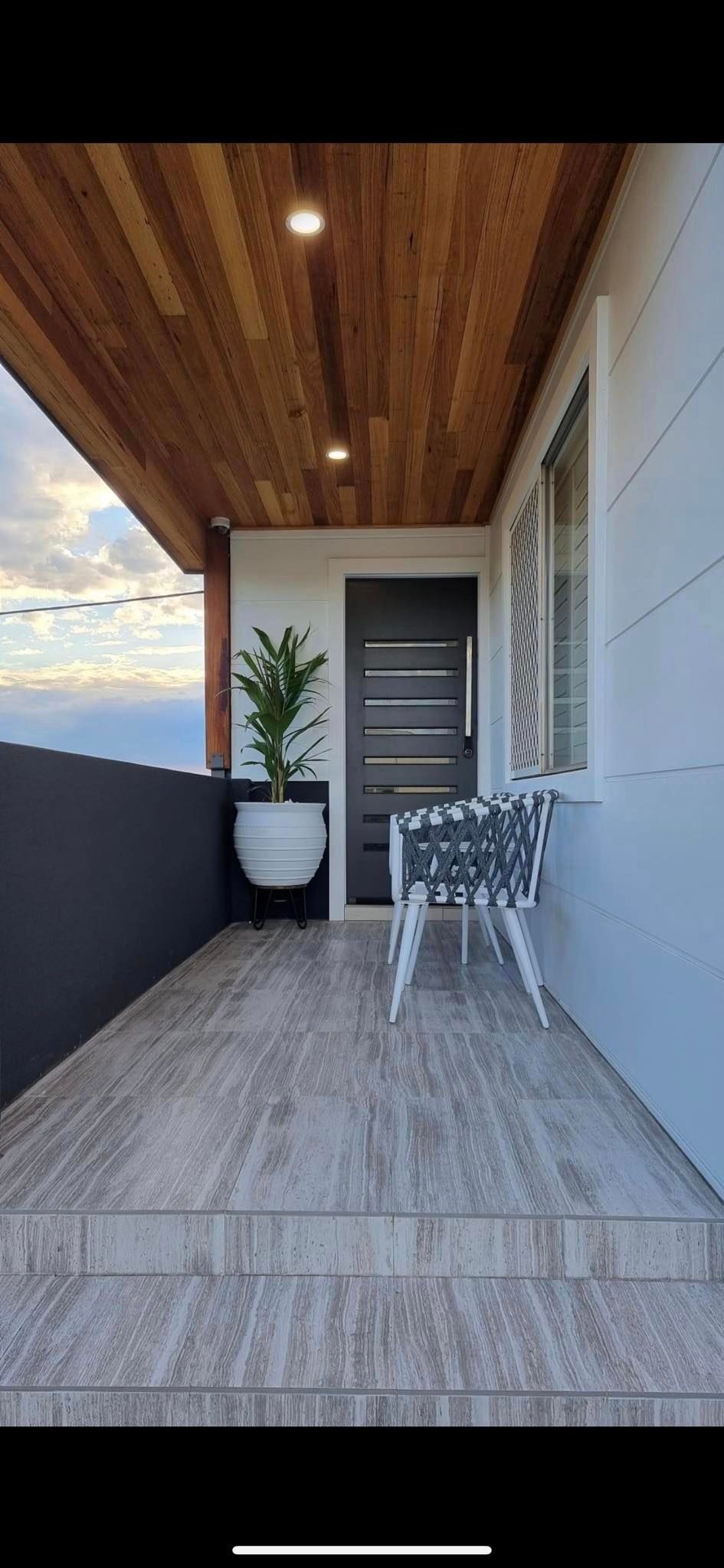 A Balcony With Wood Ceiling and White Tiles — Corrimal Discount Tiles and Bathroomwear in East Corrimal, NSW