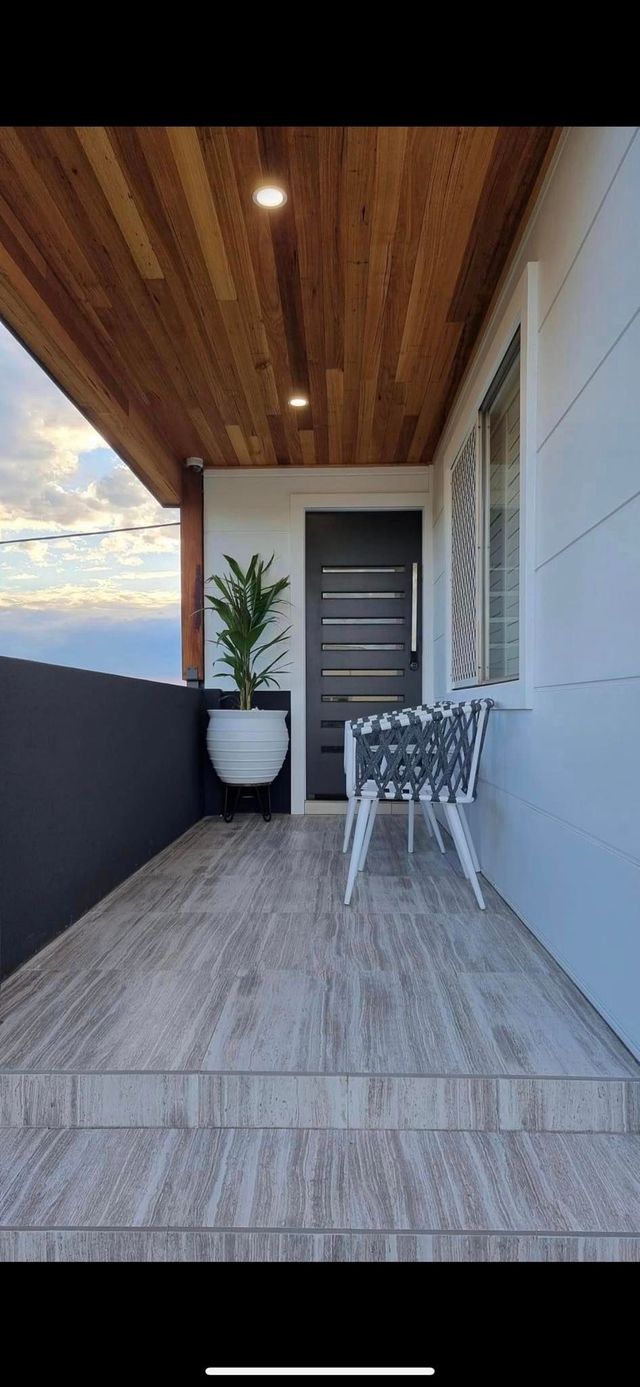 A Balcony With Wood Ceiling and White Tiles — Corrimal Discount Tiles and Bathroomwear in East Corrimal, NSW