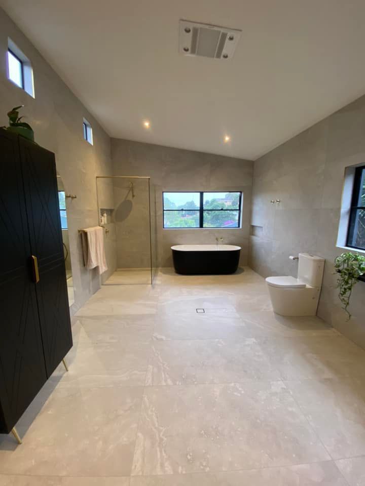 A Spacious Modern Bathroom With Black Accents — Corrimal Discount Tiles and Bathroomwear in East Corrimal, NSW