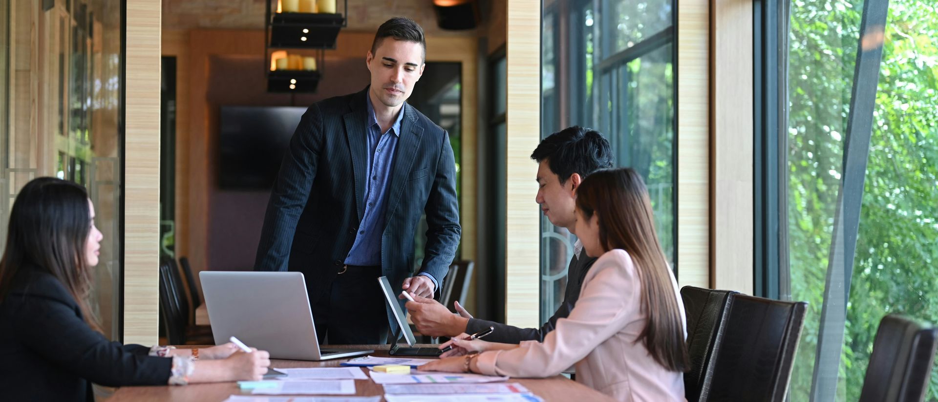 A woman in a red sweater is sitting on a chair holding a cup of coffee.