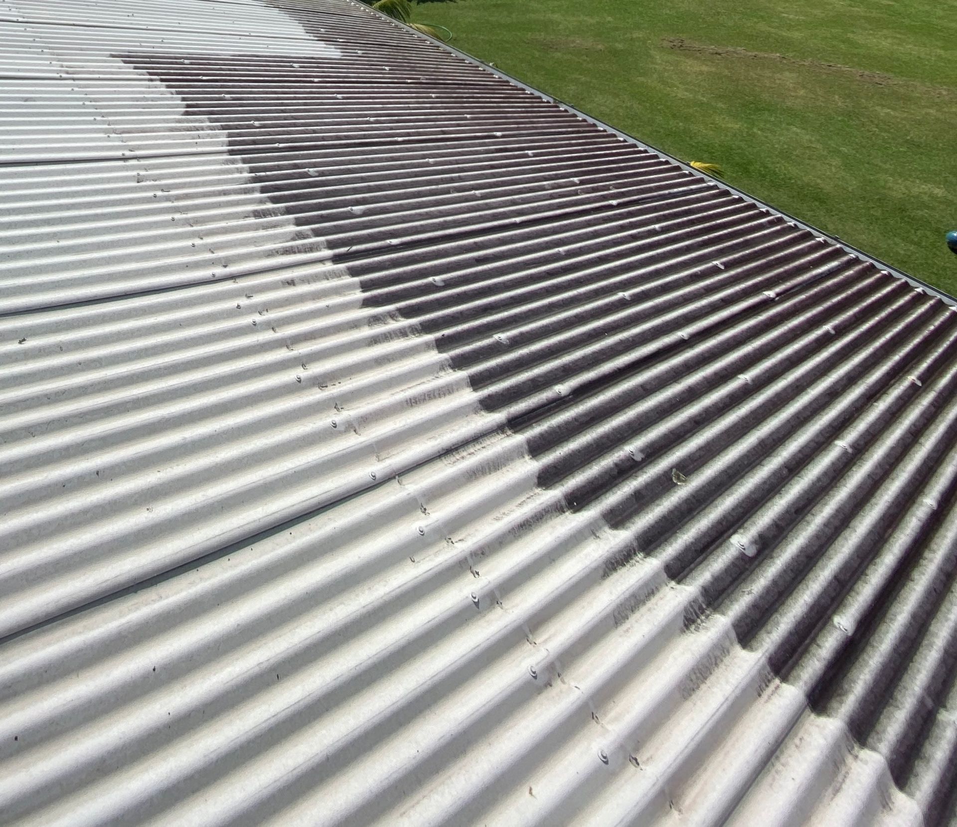 Metal roof washing service in Warkworth removing mould, dirt and salt build-up from long-run steel roofing
