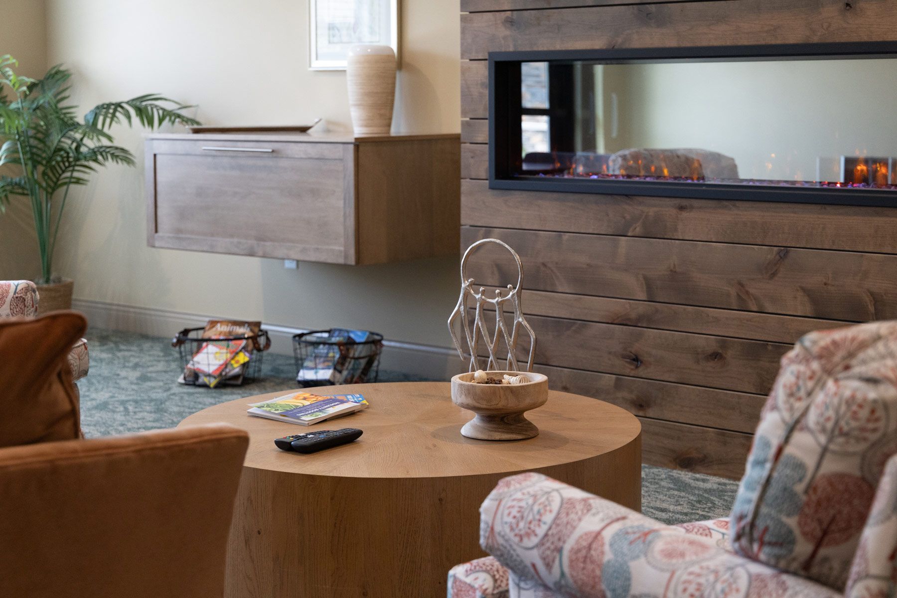 Living room with fireplace, round coffee table, and comfortable seating.