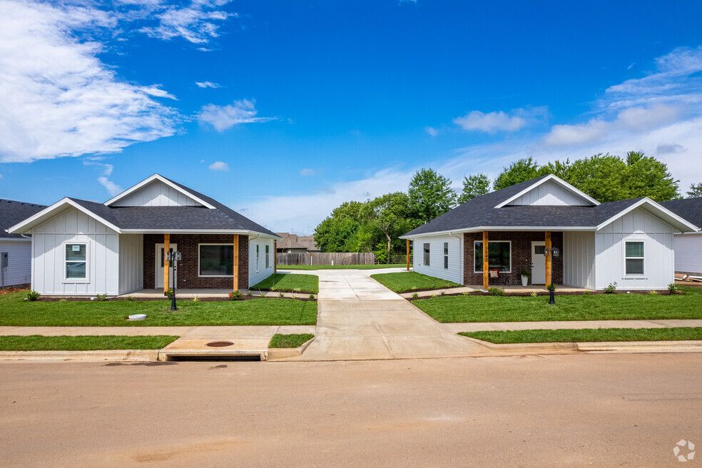 a couple of houses sitting next to each other on a residential street .