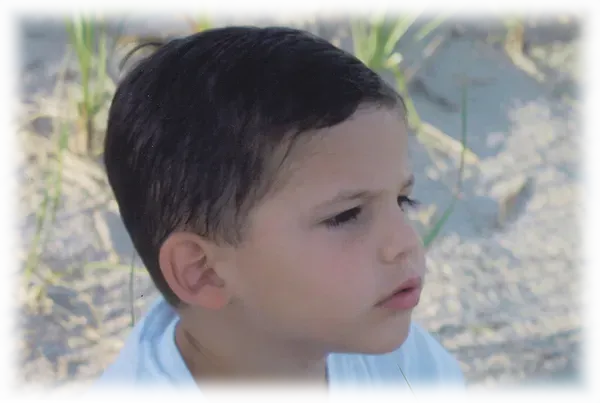 A young boy with a serious look on his face.