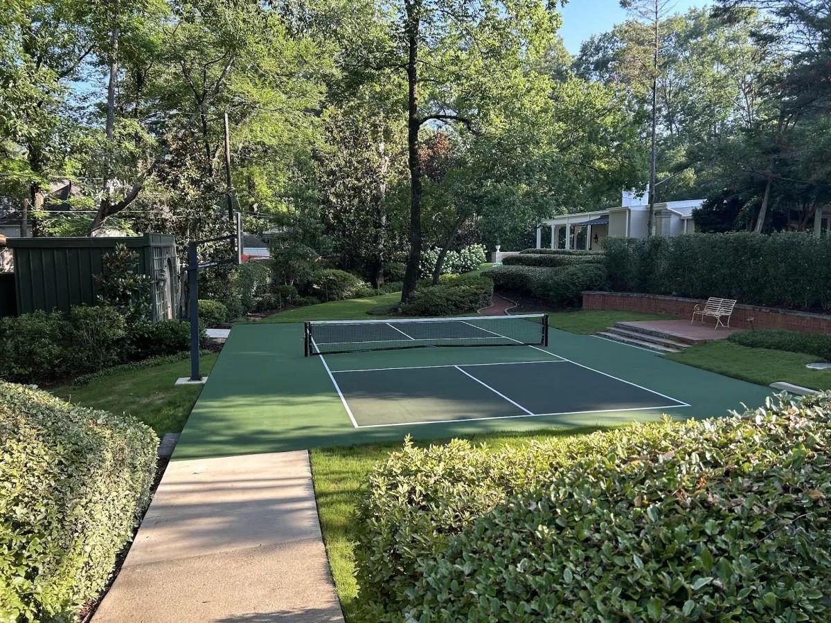 There is a Tennis Court in the Middle of a Park
