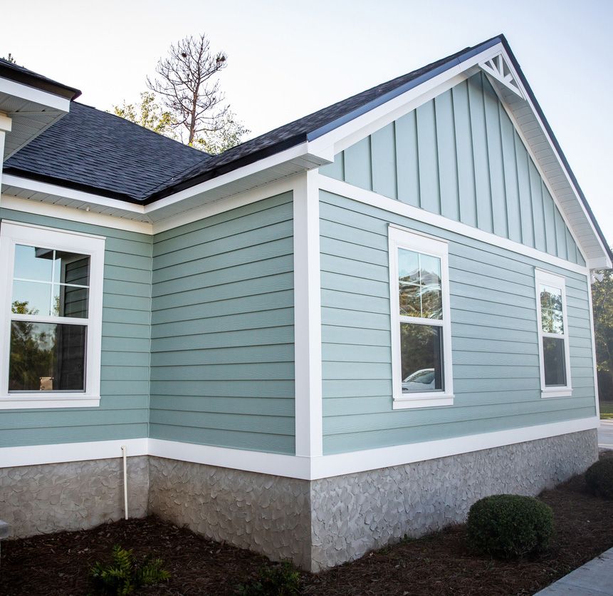 Front view of a brand new construction house with blue siding