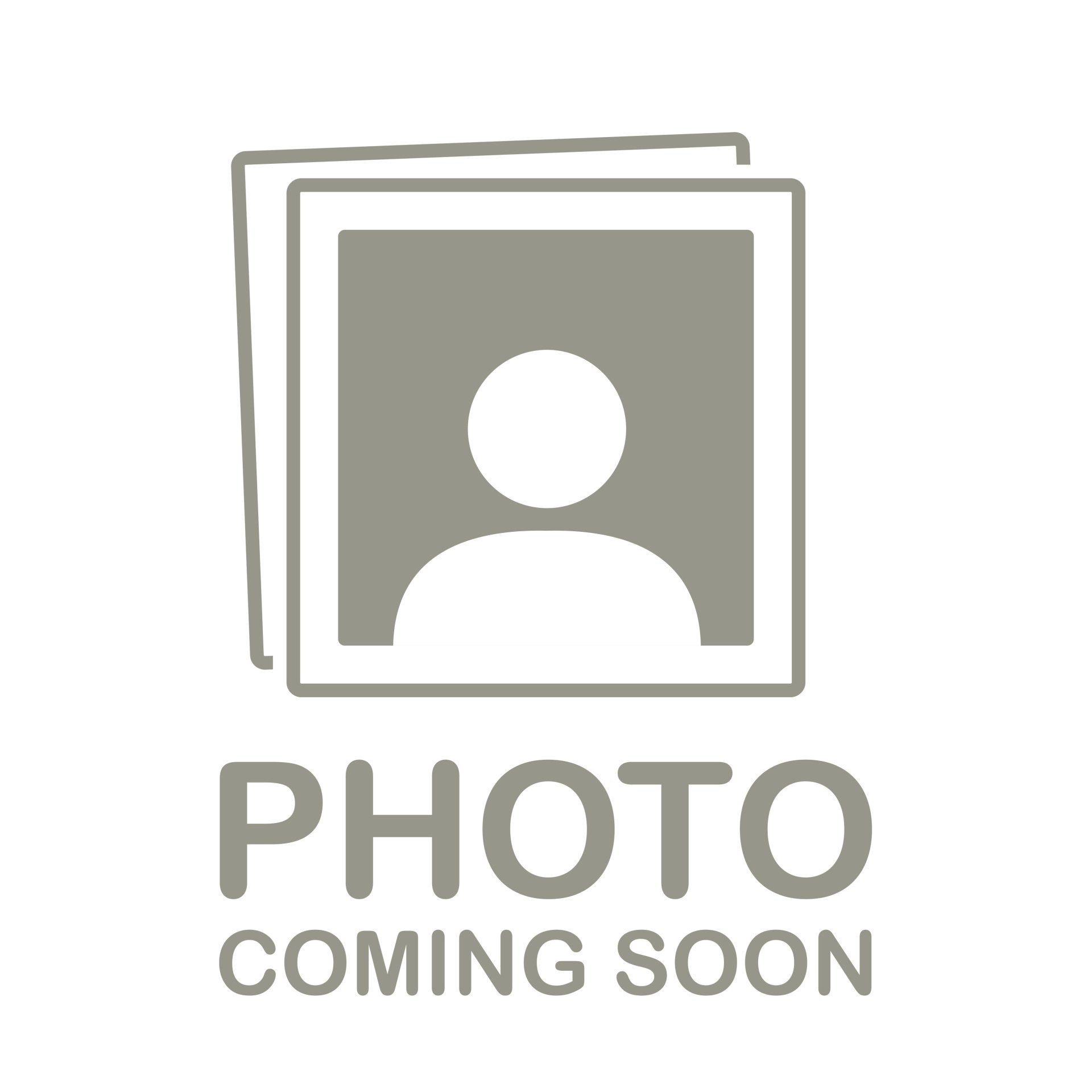 Smiling man with fair skin and a beard in a blue polo shirt, outdoors with green foliage.