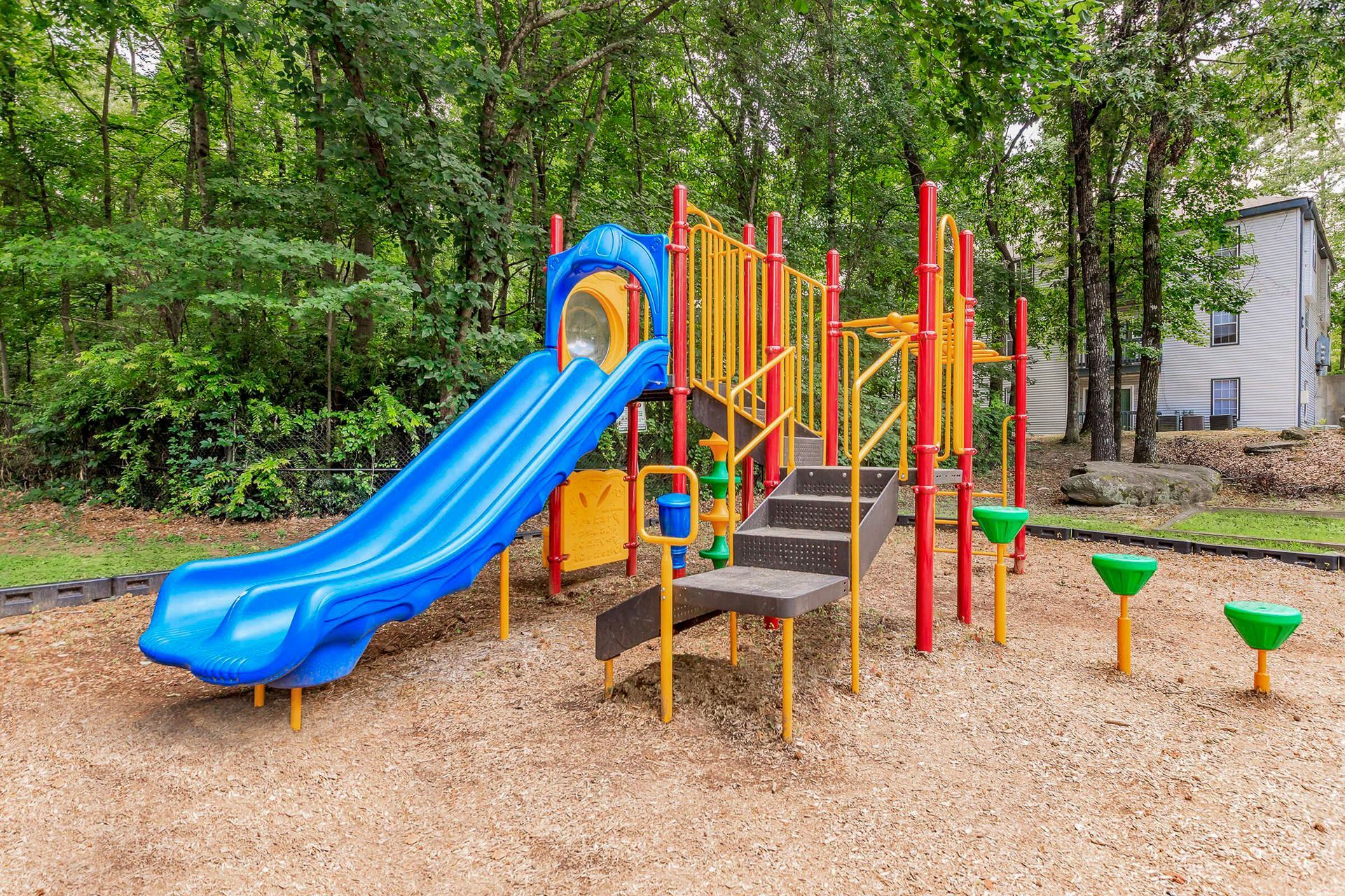 Bright room with fireplace, blue chairs, white table, and patterned armchairs.
