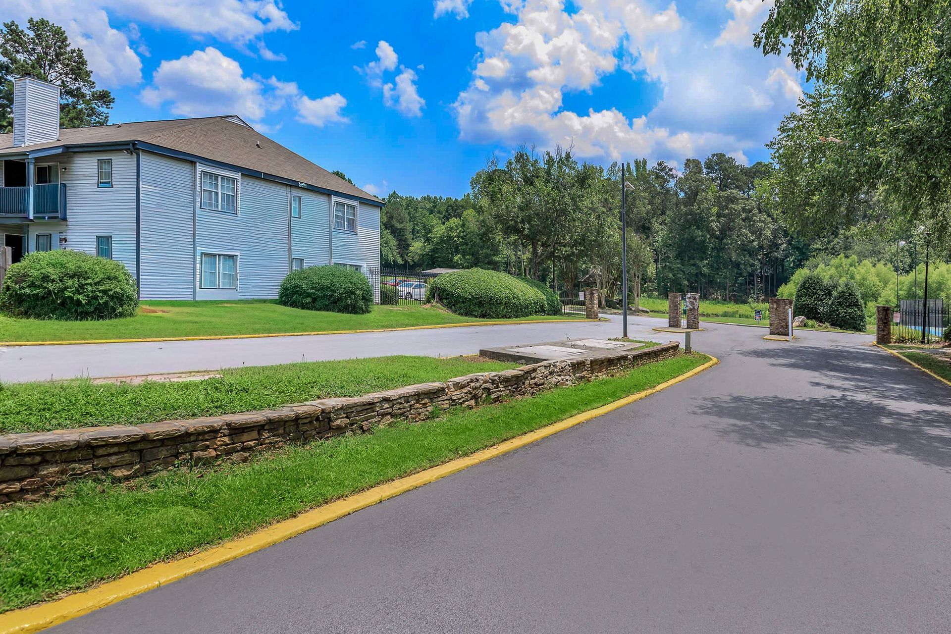 Gray kitchen with black appliances, white subway tile backsplash, and a window.
