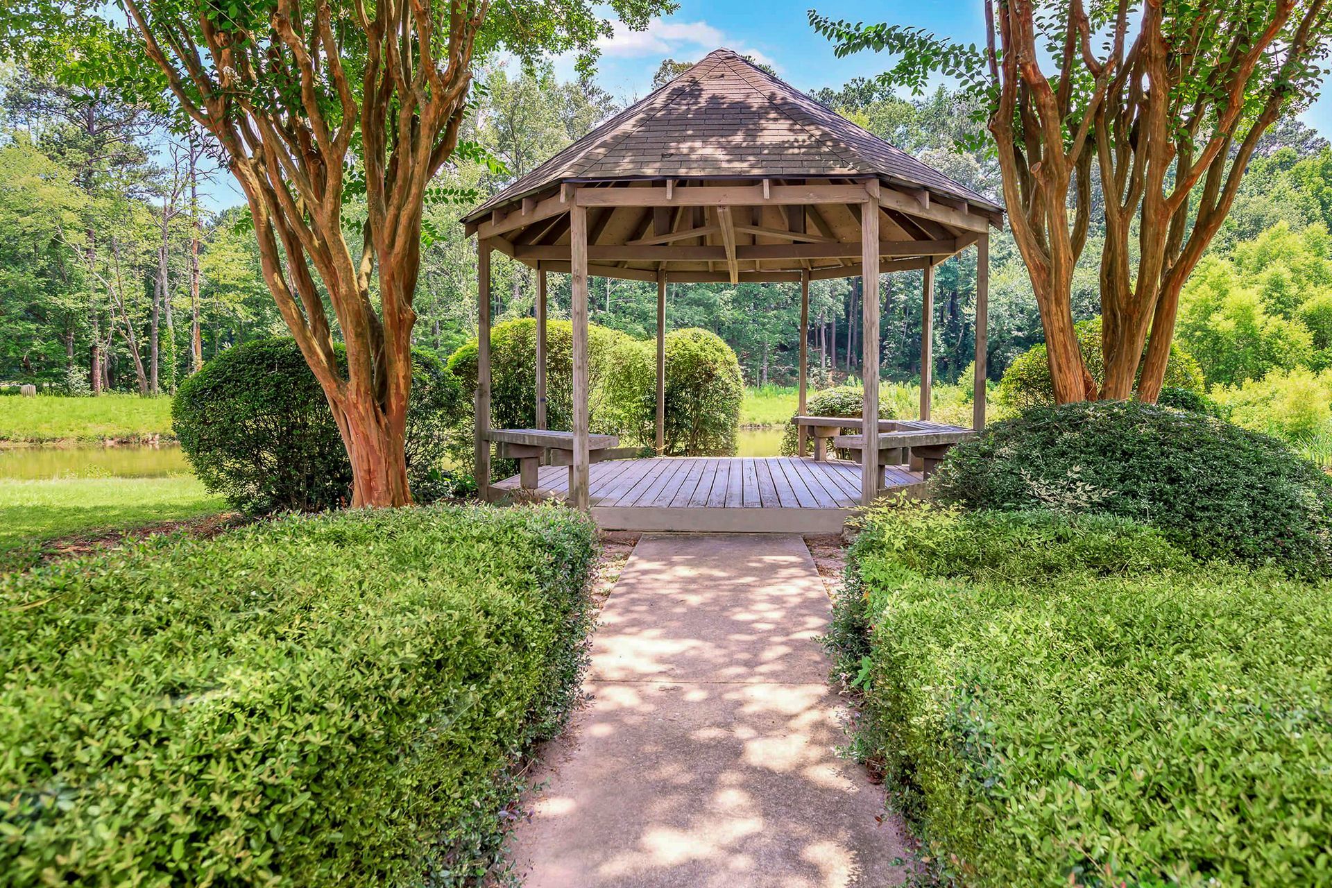 Ranch-style house with brick and gray accents, front porch, and lush landscaping.