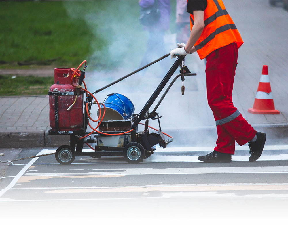 A man operating a line marking machine.