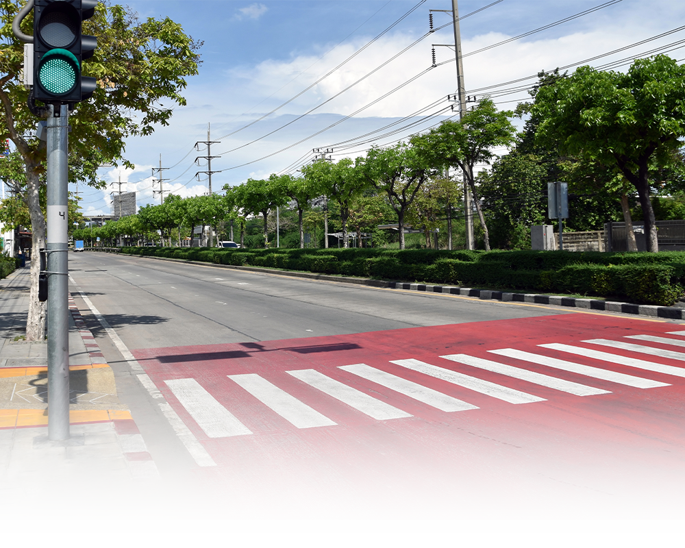A green traffic light is sitting on the side of a road next to a crosswalk.