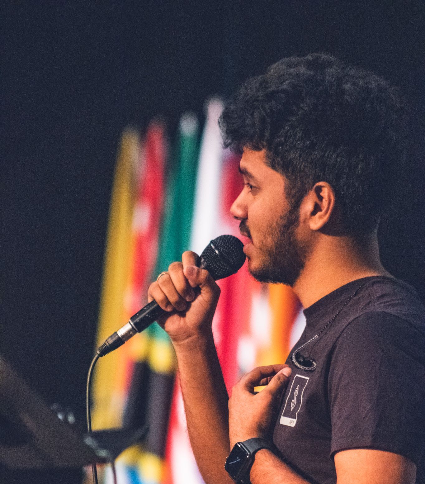 A student sings on stage during chapel