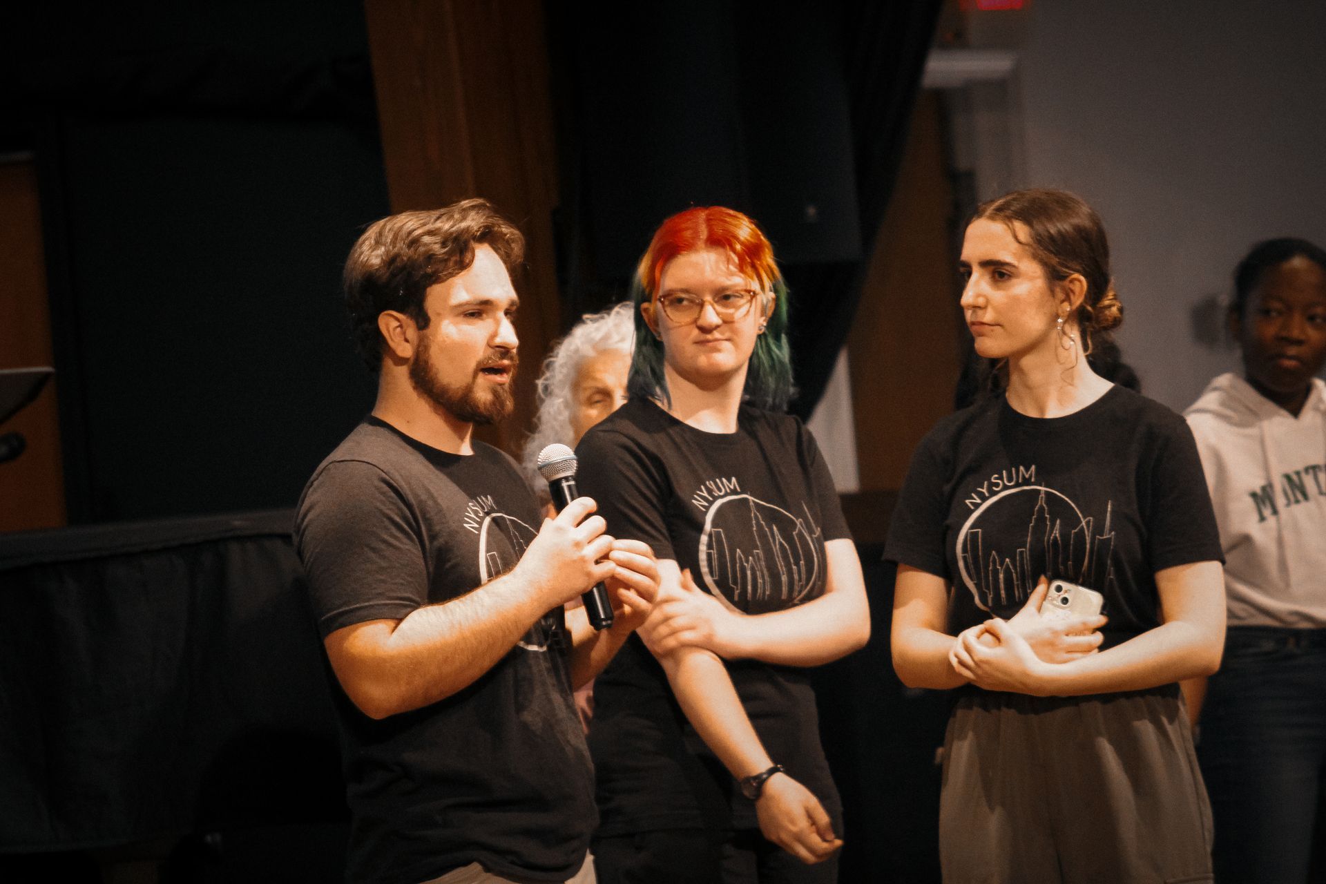Three students speakingin a chapel service