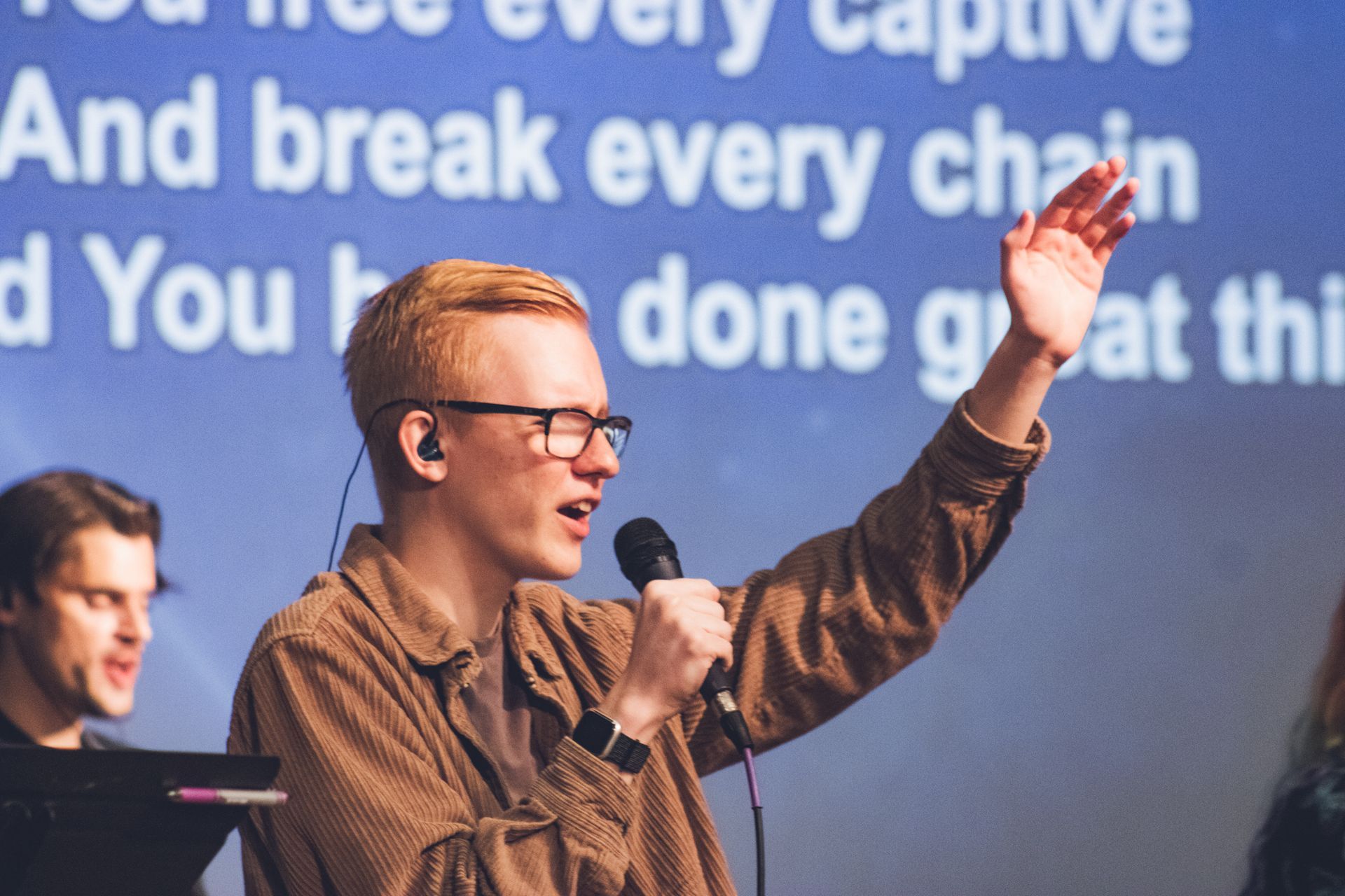 A male student leads worship during a chapel 